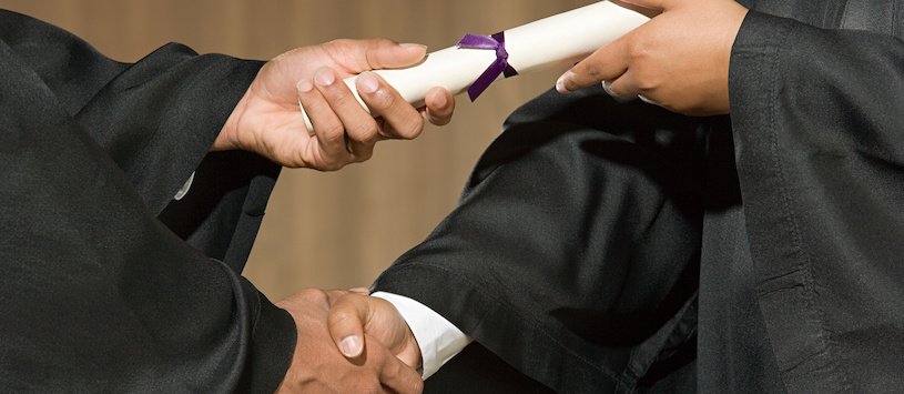A graduate receiving their diploma.