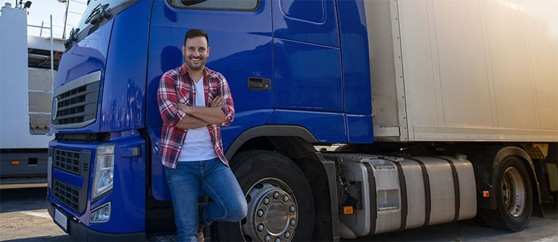 Man standing in front of a semi-truck.